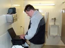 Nils downloading pictures from the camera in the men's room